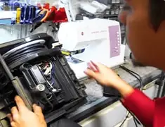 Vacuum repair technician servicing internal components on a workbench in Chandler, AZ